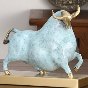Luxury sky blue enamel bull ornament displayed on a modern office desk.