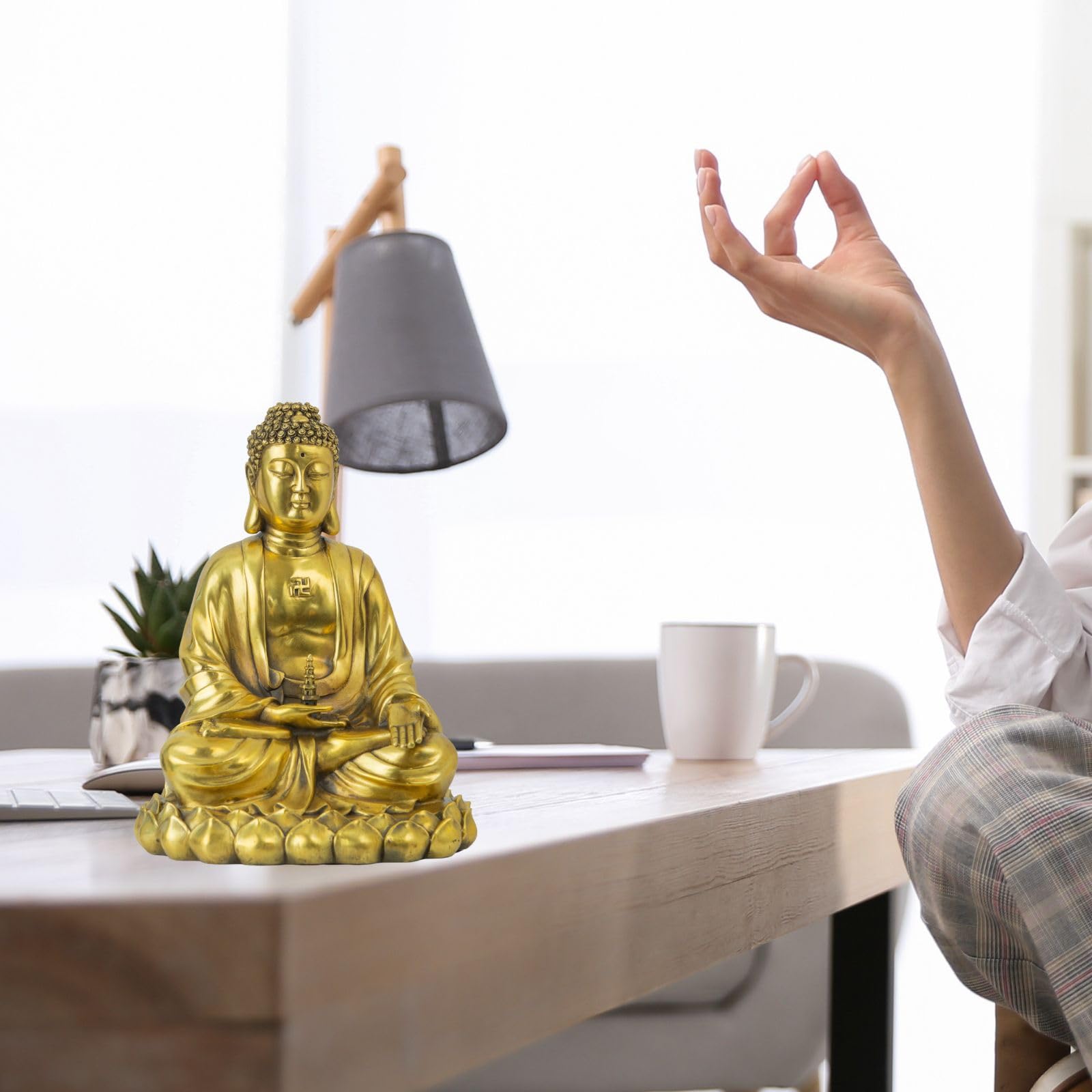 Solid brass Buddha statue shown in two lifestyle scenes: desk display and meditation setting with lamp