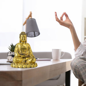 Solid brass Buddha statue shown in two lifestyle scenes: desk display and meditation setting with lamp