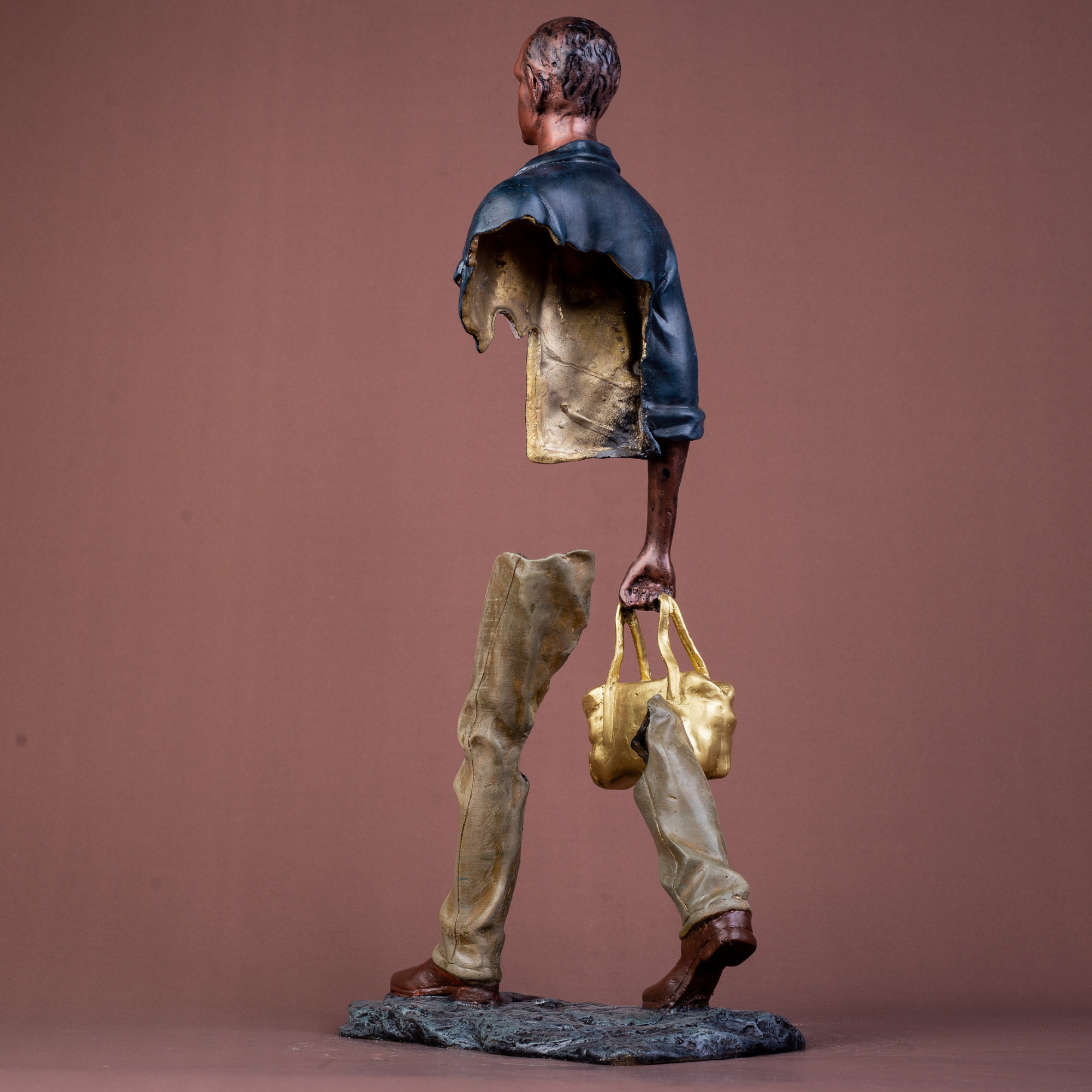 Macro shot showing the texture of the solid cast bronze and hand-painted navy jacket.