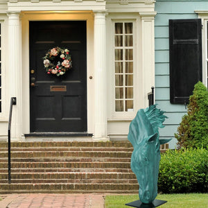 Still Water horse head bronze sculpture in emerald patina displayed beside front door entryway decor