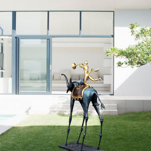Surrealist bronze elephant statue displayed on garden lawn as outdoor abstract art sculpture