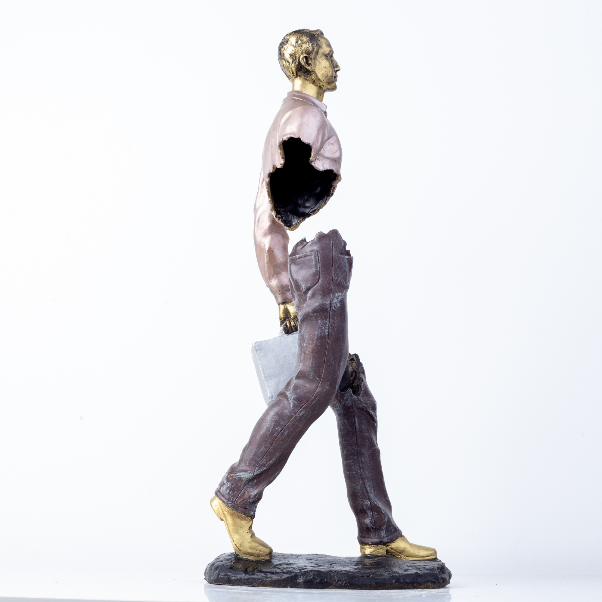 Side view profile of surrealist hollowed-out bronze traveler statue.