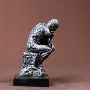 The Thinker gothic silver bronze statue right side view showing full seated figure and pedestal base
