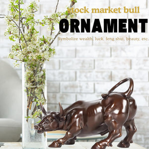 Classic brown brass bull decor styled on a wooden home office desk.