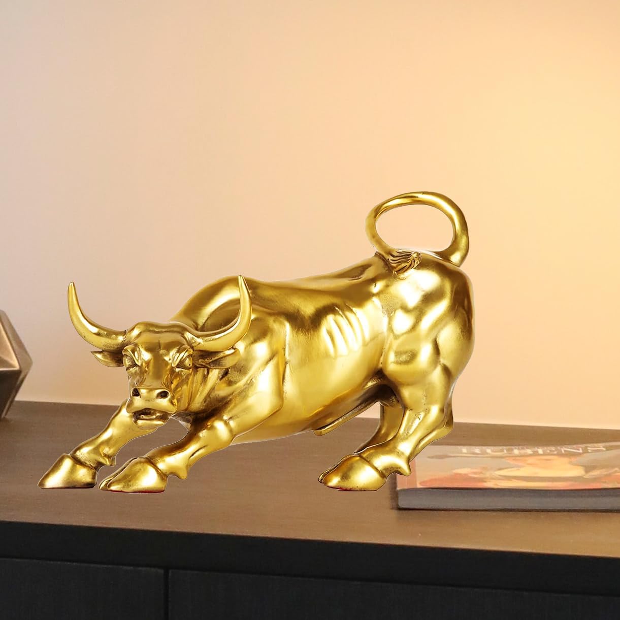 Front close-up of gold brass Wall Street bull horn detail.