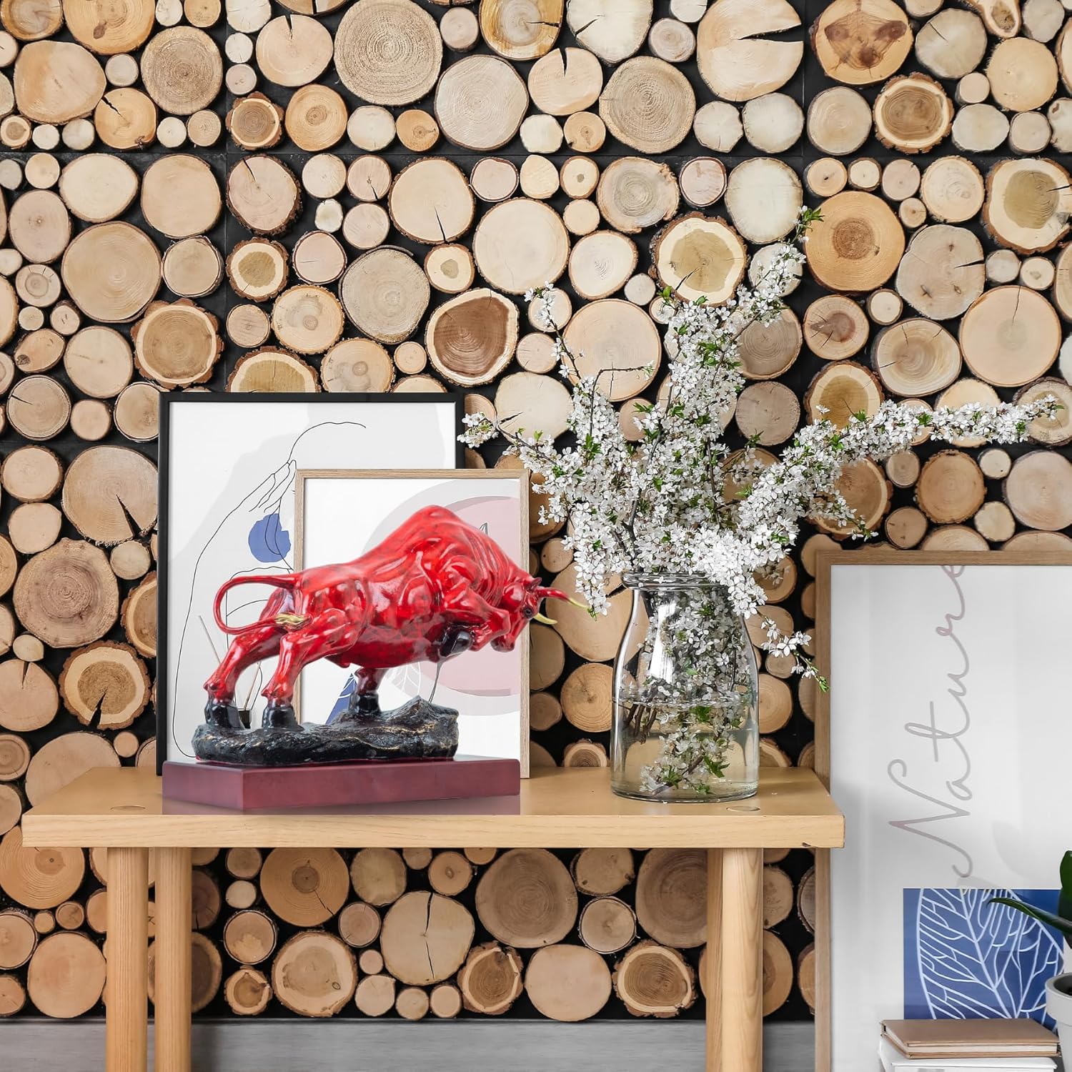 Red patina bull sculpture styled on fireplace mantel decor.