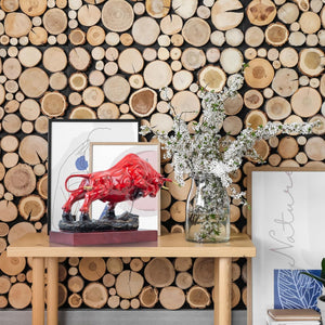 Red patina bull sculpture styled on fireplace mantel decor.