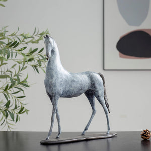 17.3-inch white bronze minimalist horse sculpture displayed indoors with abstract art and greenery decor
