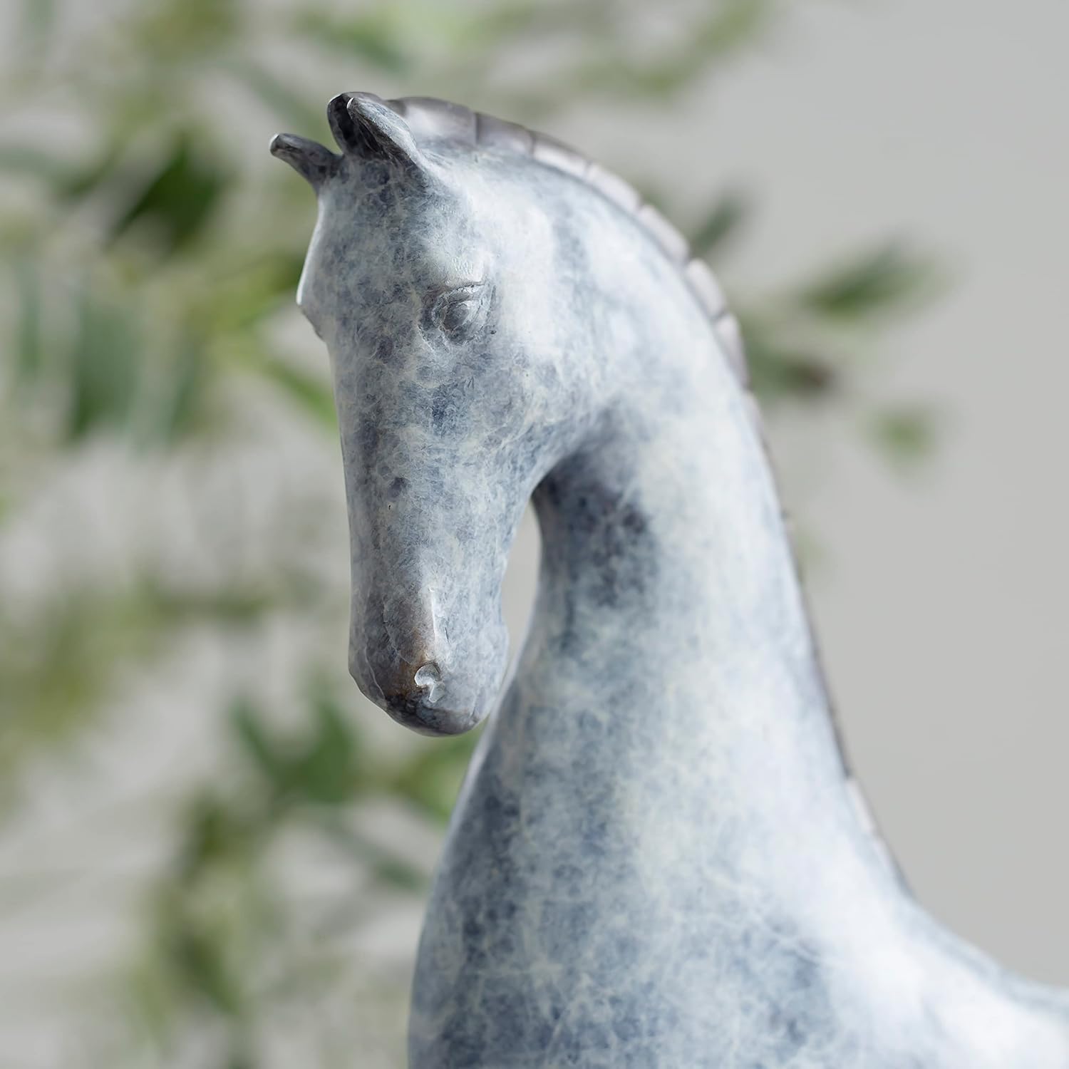 Close-up front detail of white bronze minimalist horse sculpture head showing textured surface finish