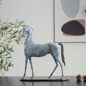 White bronze minimalist horse sculpture front angle view displayed with abstract art background
