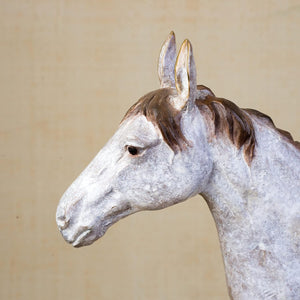 Close-up side detail of white bronze horse sculpture head showing ears and facial features