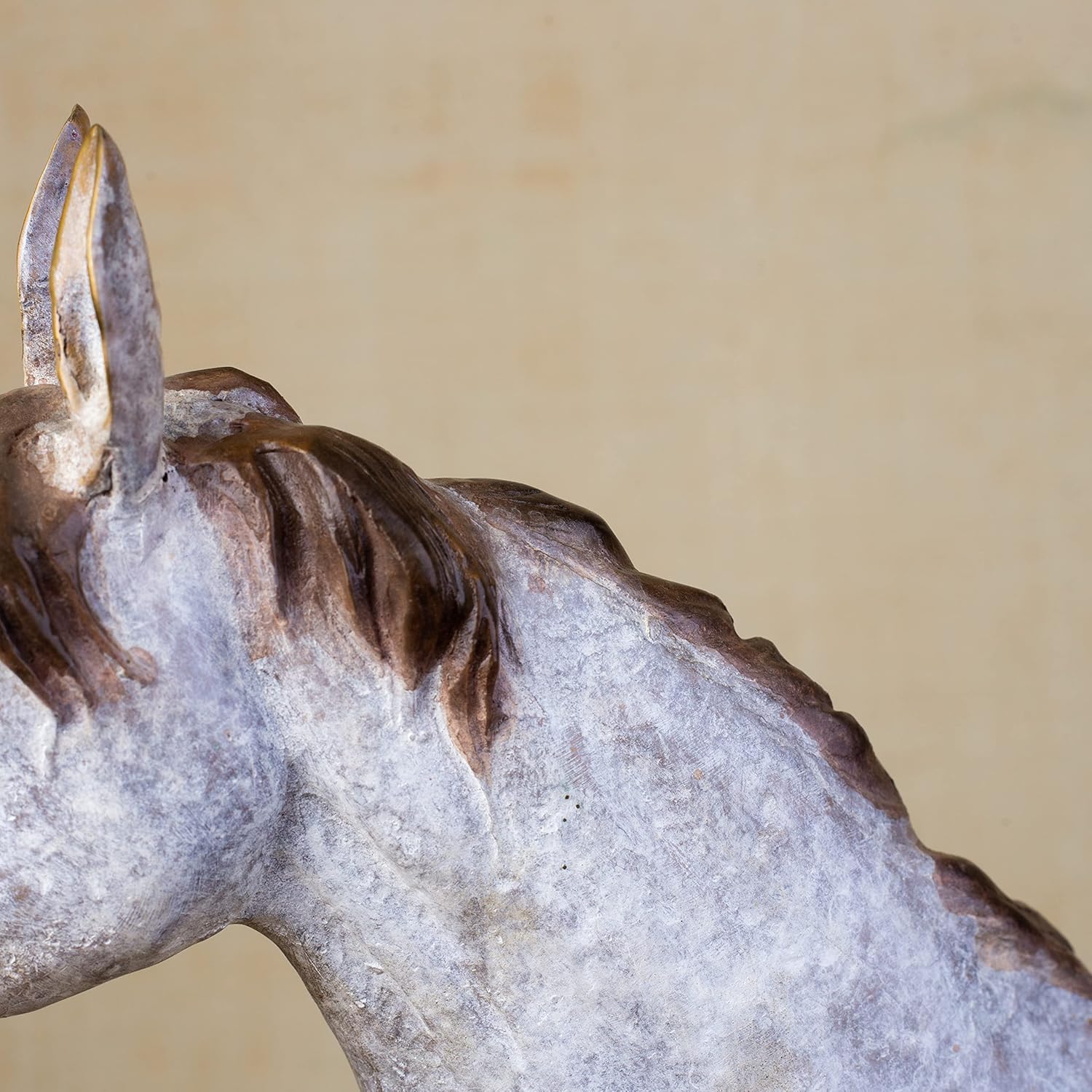 Close-up detail of white bronze horse sculpture mane and neck showing textured surface finish