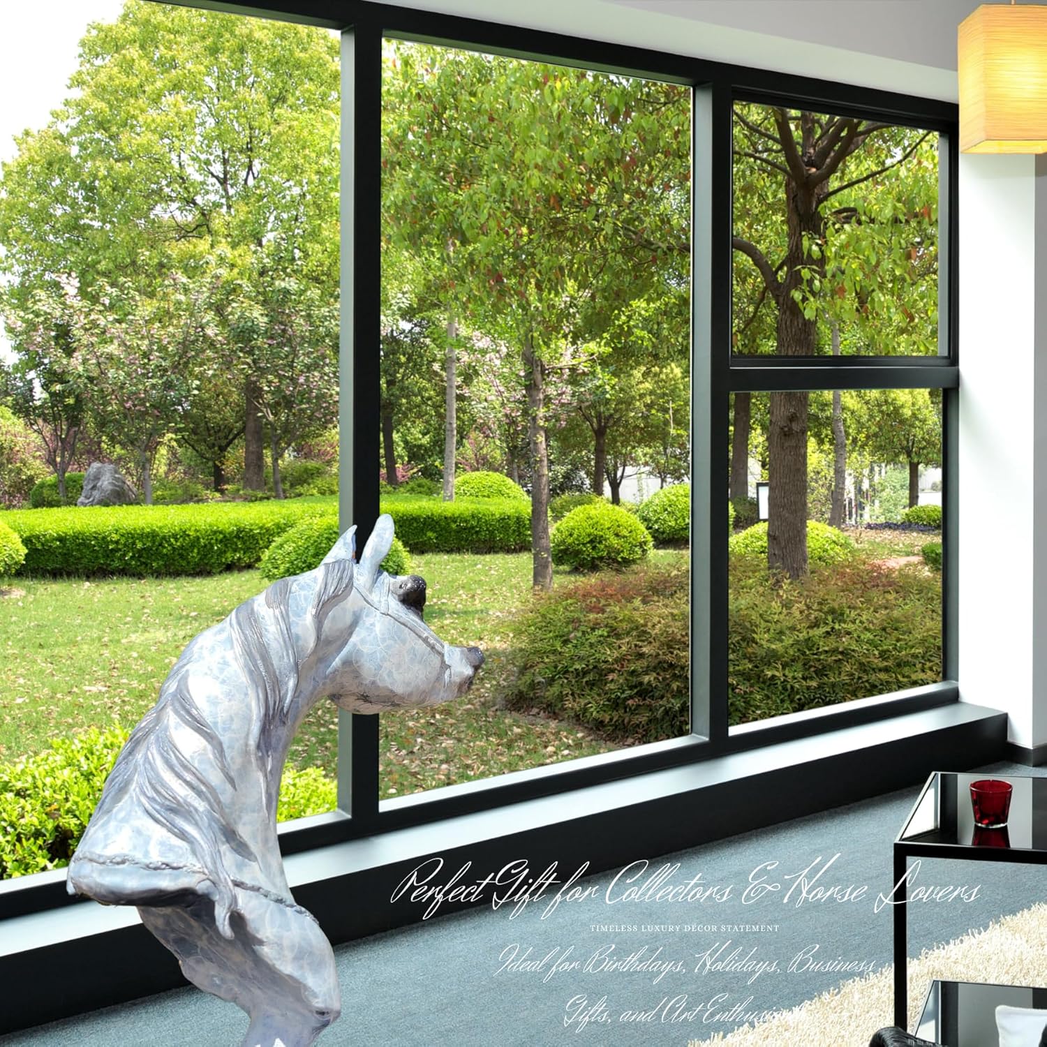 White patina bronze Arabian horse head sculpture displayed by floor-to-ceiling window with garden view