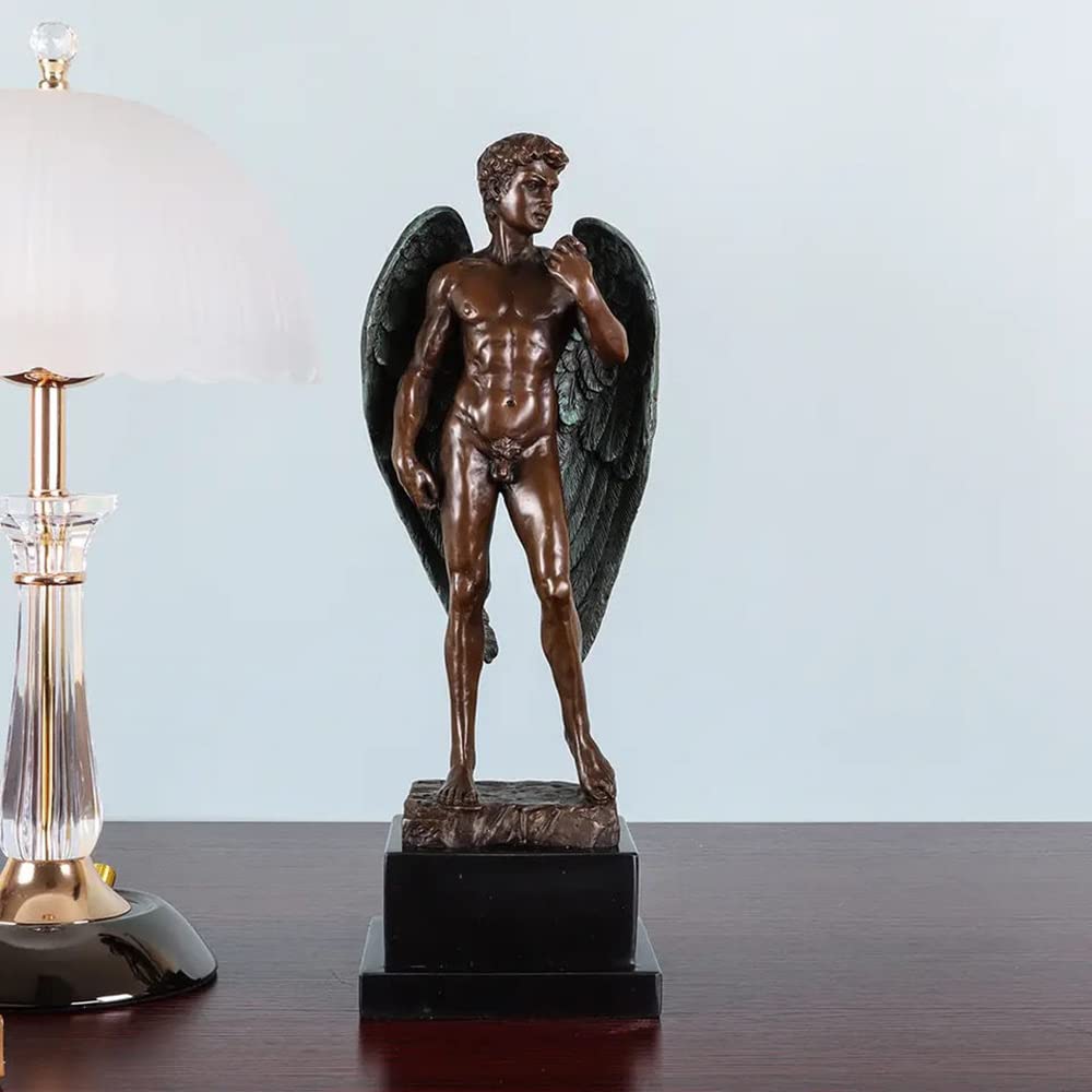 Winged David bronze sculpture displayed on dark wood desk beside crystal candlestick as office decor