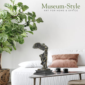 Museum-style display of Winged Victory Nike bronze statue in elegant interior setting