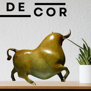 Close-up of the bull head with brass horn details and patina finish.